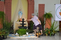 Sr. Vincenza memasang lilin bernyala di depan patung Bunda Maria